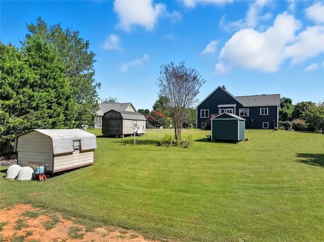 a front view of a house with a garden and yard
