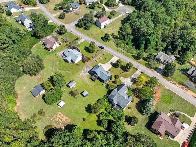 an aerial view of residential houses with outdoor space