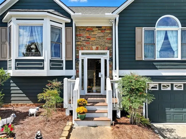 a front view of a house with a garden