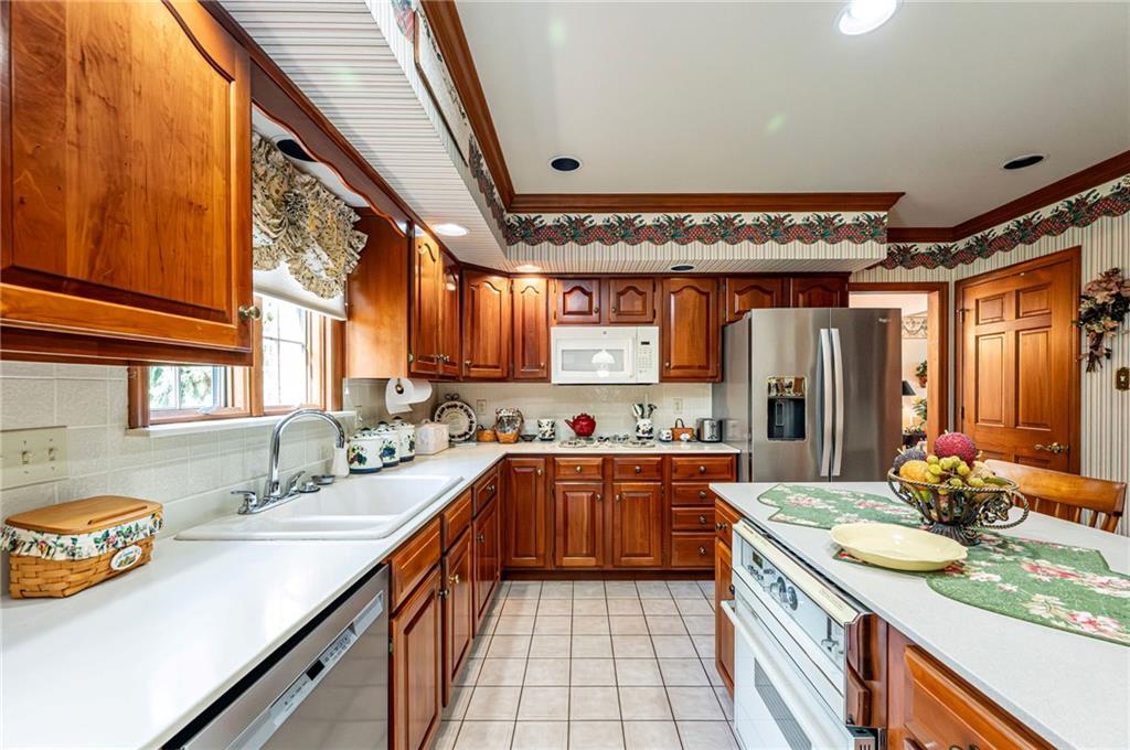 1118 Sandstone Road Greensburg, PA 15601 - Photo 13 of 50 a kitchen with a sink stove and cabinets