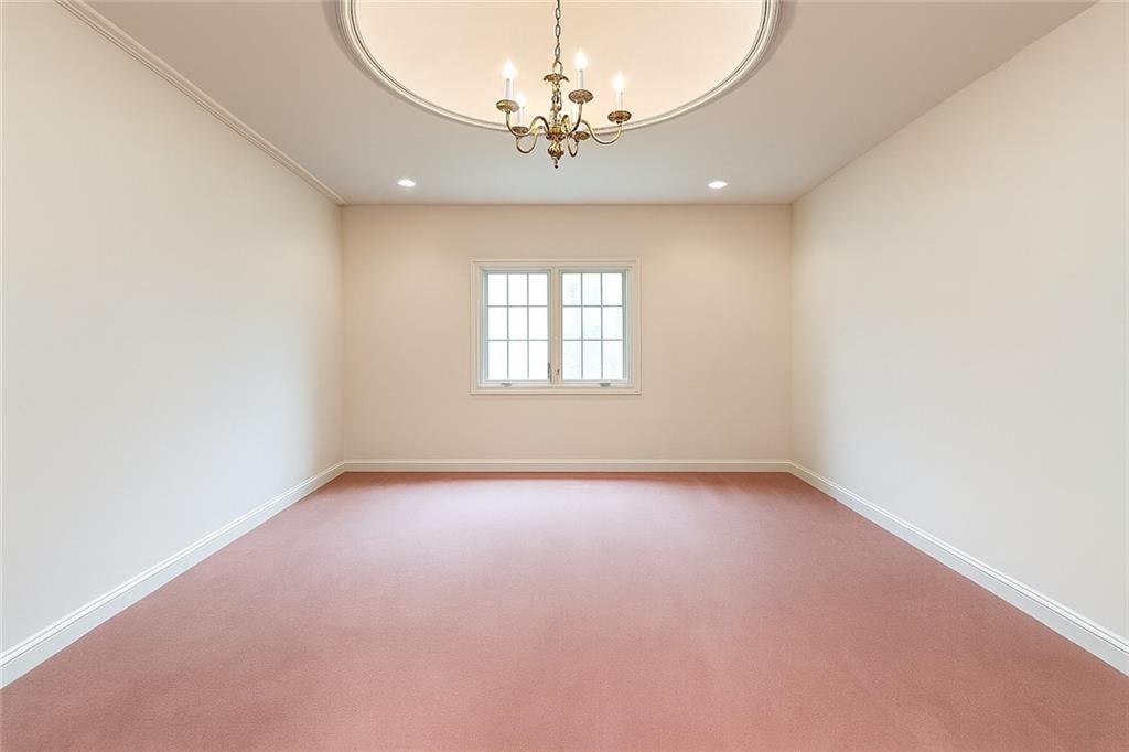 1118 Sandstone Road Greensburg, PA 15601 - Photo 23 of 50 an empty room with a chandelier fan and windows