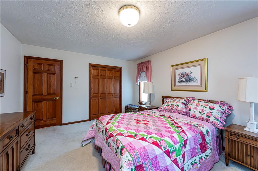 1118 Sandstone Road Greensburg, PA 15601 - Photo 32 of 50 a bedroom with a bed and a lamp