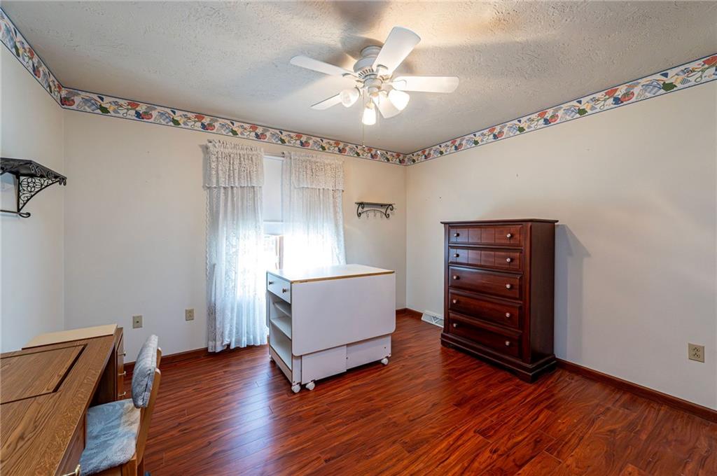 1118 Sandstone Road Greensburg, PA 15601 - Photo 36 of 50 a room with furniture and wooden floor