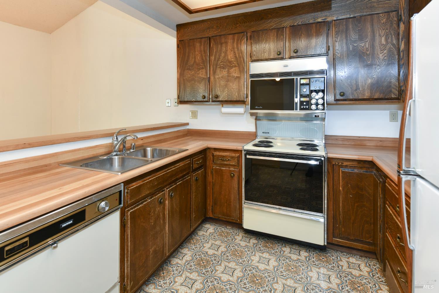 3007 Loma Court Santa Rosa, CA 95405 - Photo 12 of 43 Lots of cabinet space. Older stove with built in microwave, dishwasher.