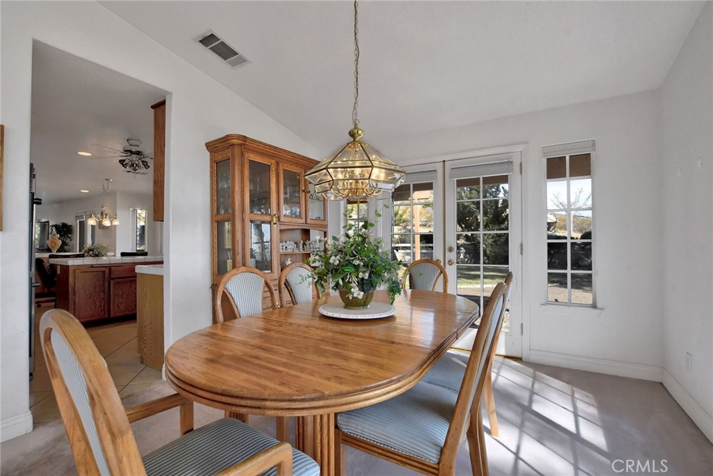 18032 Ohna Road Apple Valley, CA 92307 - Photo 13 of 65 a view of a dining room with furniture window and wooden floor