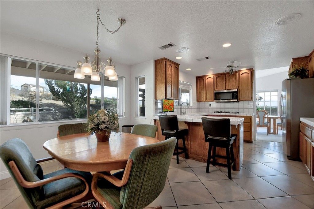 18032 Ohna Road Apple Valley, CA 92307 - Photo 20 of 65 a view of a dining room with furniture and chandelier