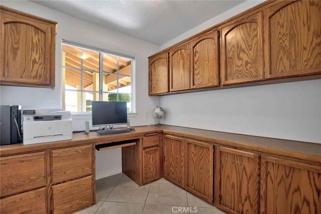 18032 Ohna Road Apple Valley, CA 92307 - Photo 28 of 65 a kitchen with stainless steel appliances granite countertop wooden cabinets a sink and a window