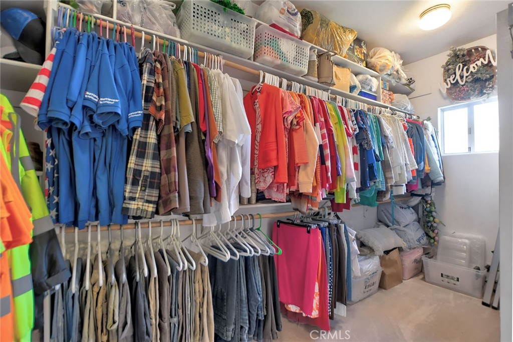 18032 Ohna Road Apple Valley, CA 92307 - Photo 40 of 65 a view of walk in closet with clothes