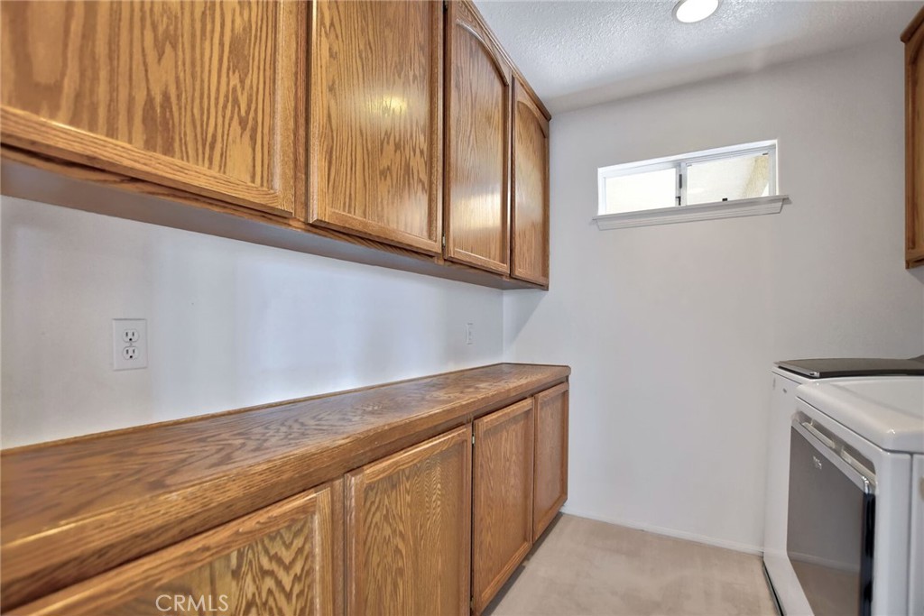 18032 Ohna Road Apple Valley, CA 92307 - Photo 43 of 65 a view of a kitchen with washer and dryer