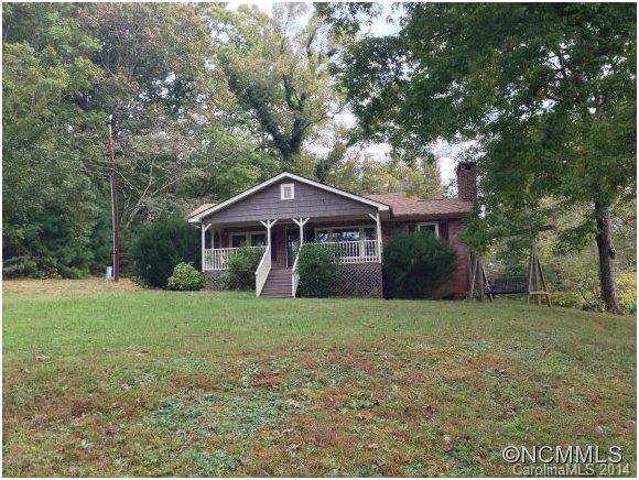1189 John Foster Road Columbus, NC 28722 - Photo 1 of 12 a front view of a house with a garden