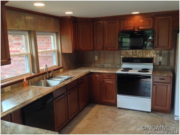 1189 John Foster Road Columbus, NC 28722 - Photo 3 of 12 a kitchen with stainless steel appliances a stove a sink and a microwave