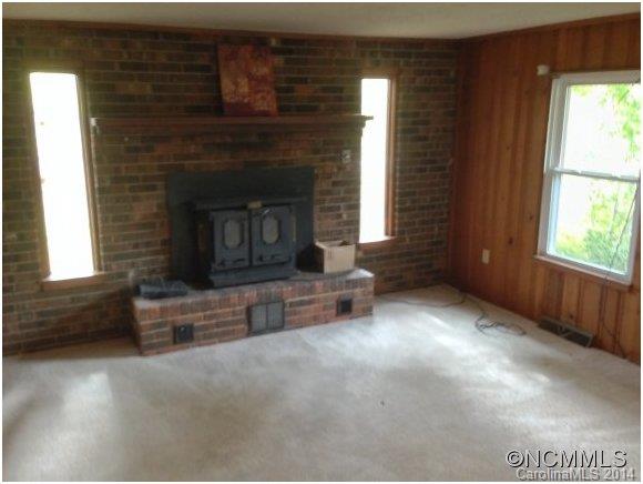 1189 John Foster Road Columbus, NC 28722 - Photo 5 of 12 a living room with furniture and a fireplace