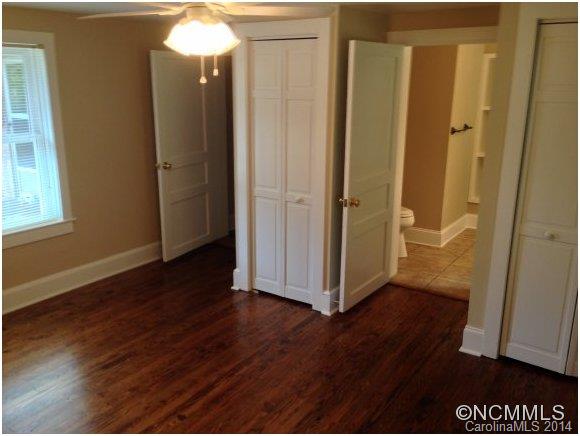 1189 John Foster Road Columbus, NC 28722 - Photo 6 of 12 an empty room with wooden floor and windows