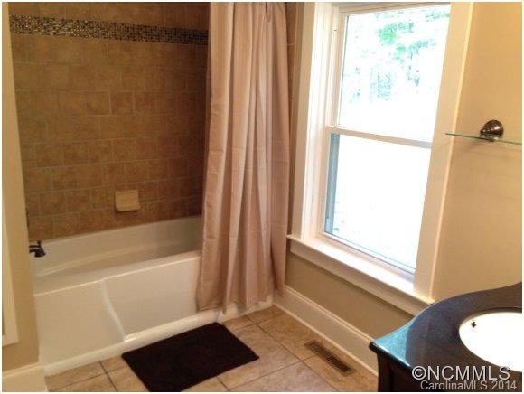 1189 John Foster Road Columbus, NC 28722 - Photo 7 of 12 a bathroom with a bathtub and a shower