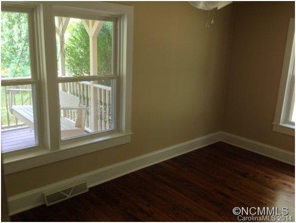 1189 John Foster Road Columbus, NC 28722 - Photo 8 of 12 a view of an empty room with wooden floor and a window