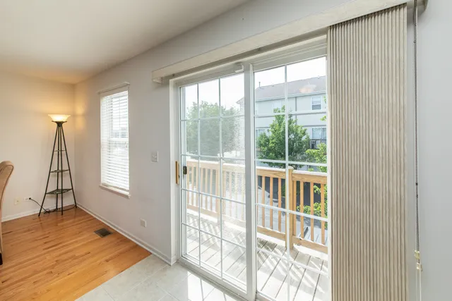 a view of a room with wooden floor and windows