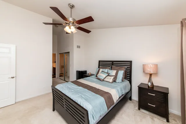 a bedroom with a bed and a lamp