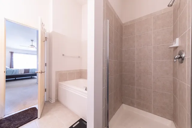 a bathroom with a tub a sink and a shower