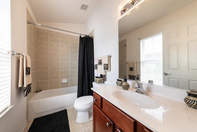 a bathroom with a sink toilet tub and shower