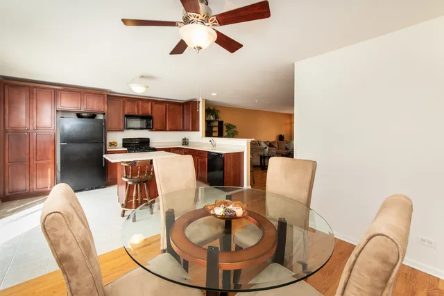 a view of a dining room with furniture a kitchen and chandelier