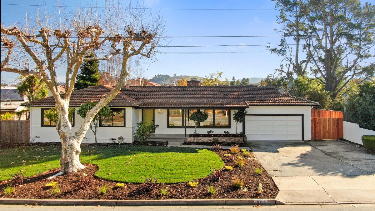 a front view of a house with garden