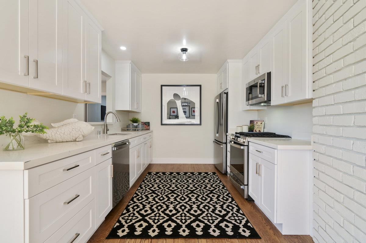 2135 Queens Lane San Mateo, CA 94402 - Photo 11 of 50 a kitchen with a sink stove and cabinets
