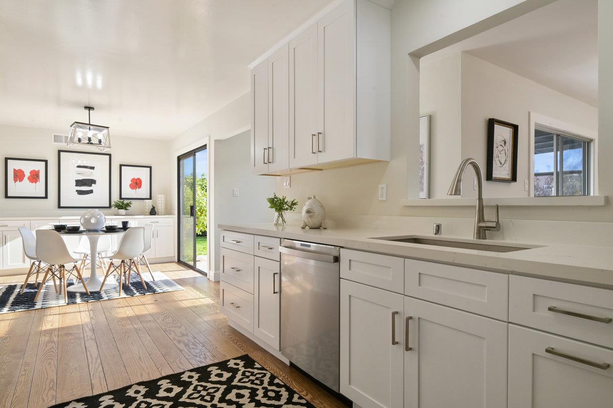 2135 Queens Lane San Mateo, CA 94402 - Photo 14 of 50 a kitchen with stainless steel appliances kitchen island granite countertop a sink and cabinets