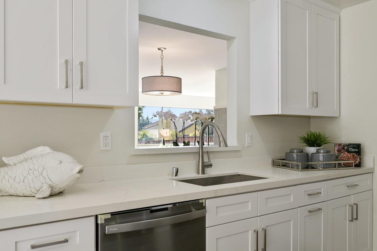 2135 Queens Lane San Mateo, CA 94402 - Photo 15 of 50 a kitchen with stainless steel appliances granite countertop a sink a stove and white cabinets