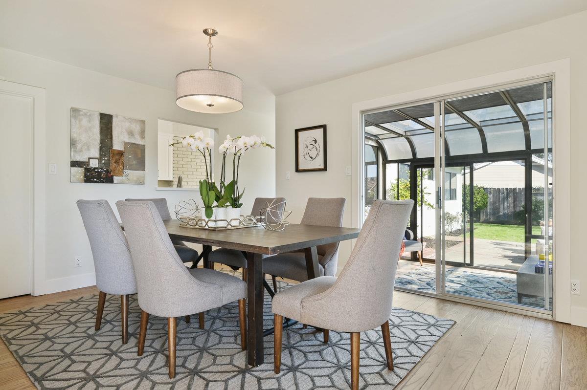 2135 Queens Lane San Mateo, CA 94402 - Photo 17 of 50 a view of a dining room with furniture wooden floor and chandelier