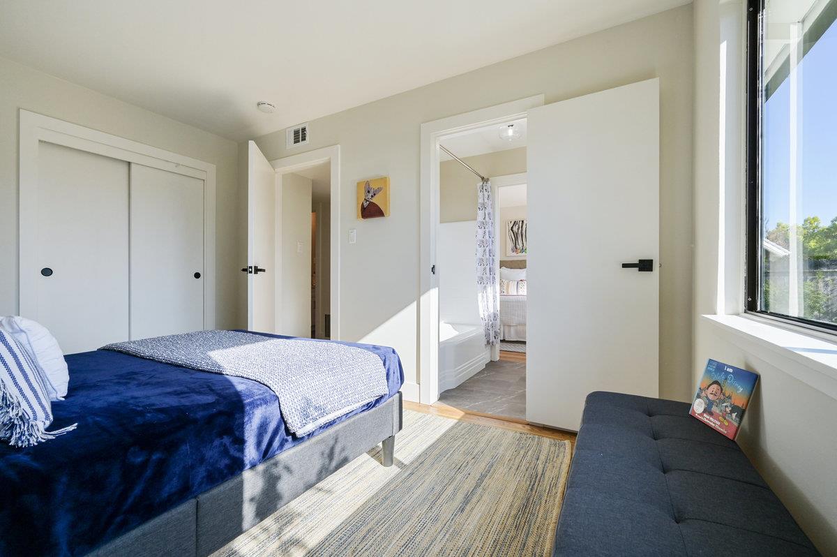 2135 Queens Lane San Mateo, CA 94402 - Photo 31 of 50 a bedroom with a bed and wooden floor