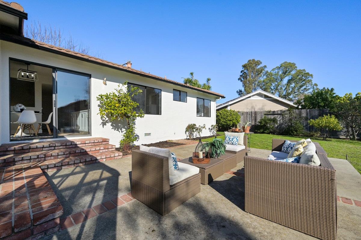 2135 Queens Lane San Mateo, CA 94402 - Photo 37 of 50 a view of a patio with couches table and chairs under an umbrella