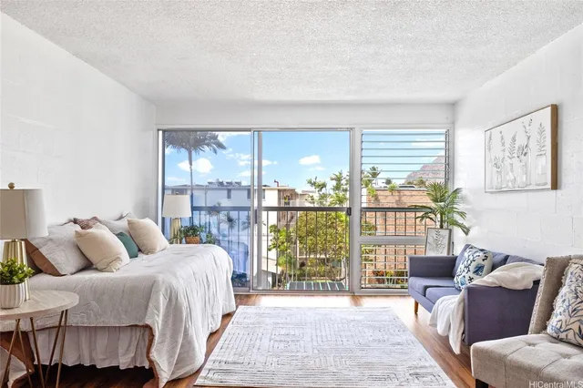a bedroom with a large bed and a large window