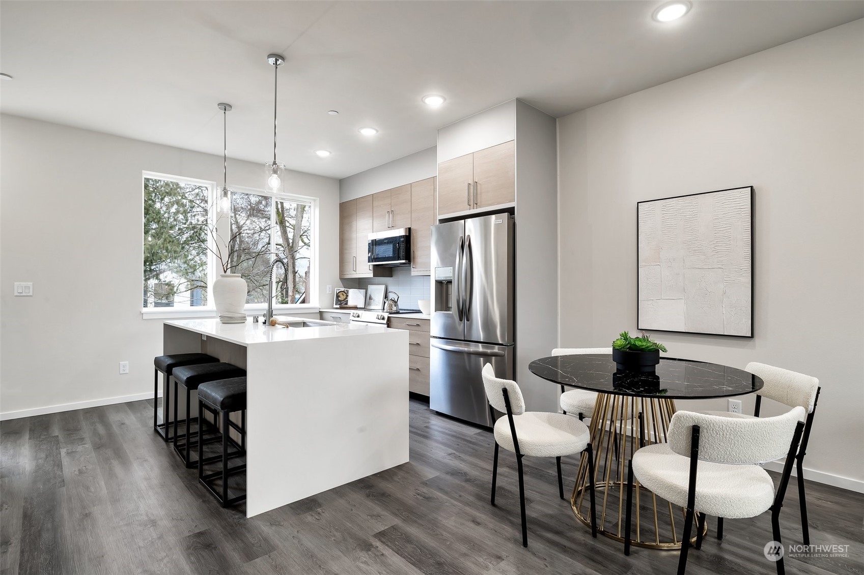 4549 Renton Avenue South, Unit D Seattle, WA 98108 - Photo 3 of 15 a kitchen with a dining table chairs stainless steel appliances and wooden floor