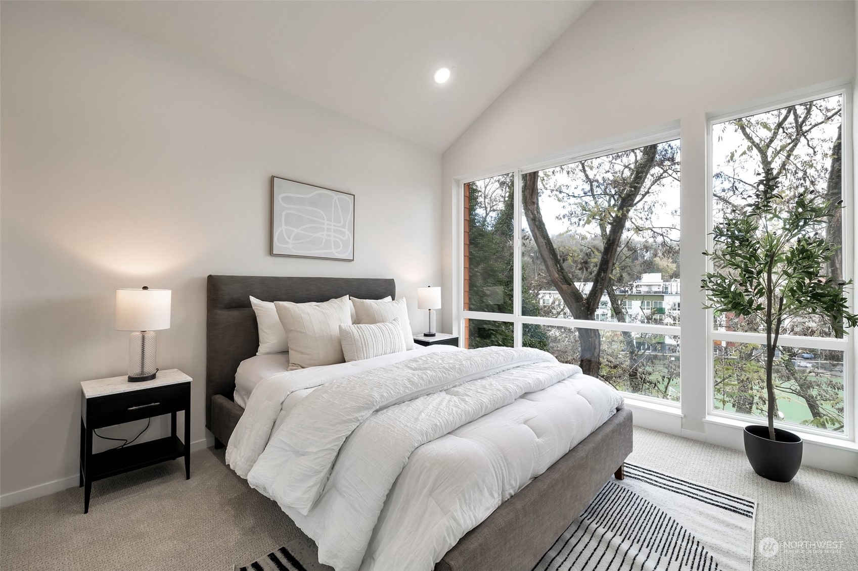 4549 Renton Avenue South, Unit D Seattle, WA 98108 - Photo 8 of 15 a bedroom with a balcony a bed and a large window