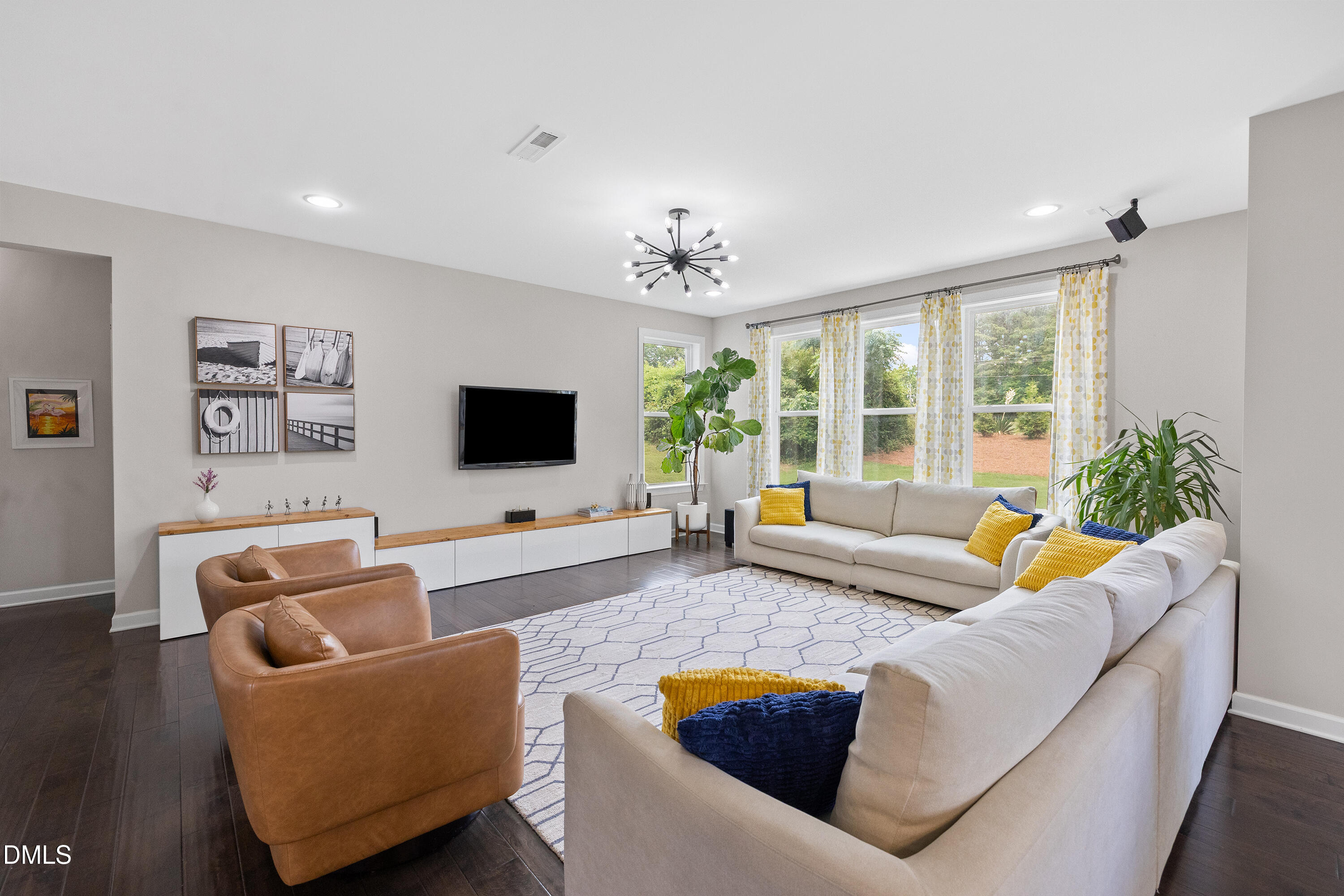 8059 Gilano Drive Raleigh, NC 27603 - Photo 21 of 43 a living room with furniture and a flat screen tv