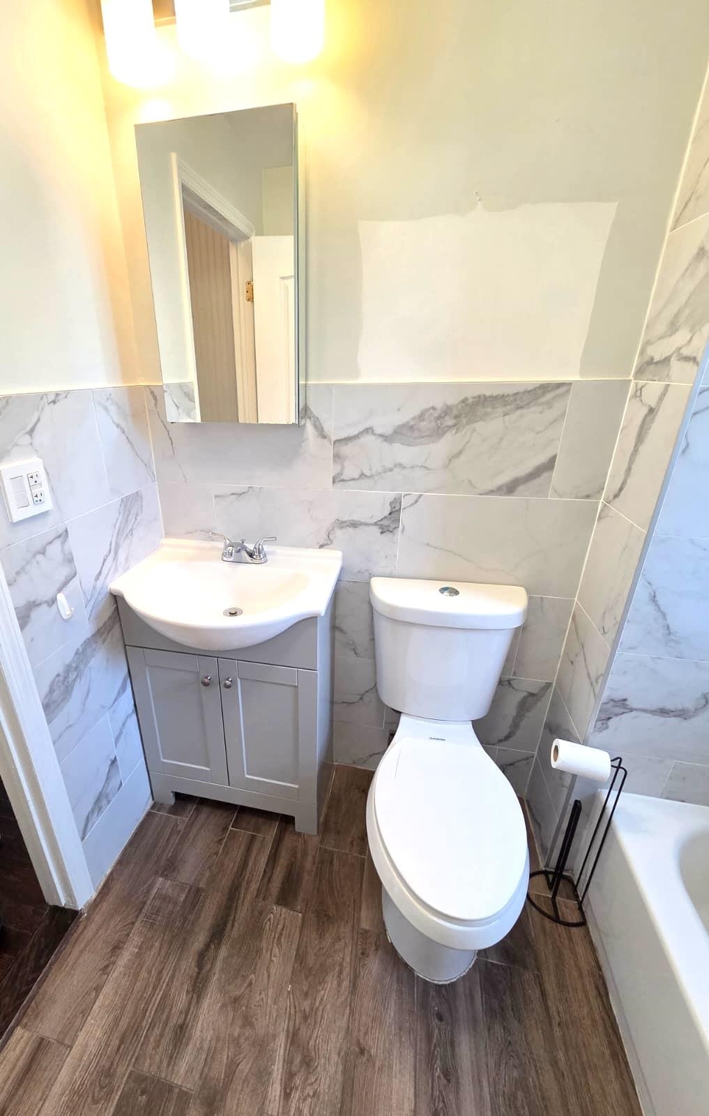 438 Devon Street, Unit 2 Kearny, NJ 07032 - Photo 11 of 27 a bathroom with a toilet sink and mirror