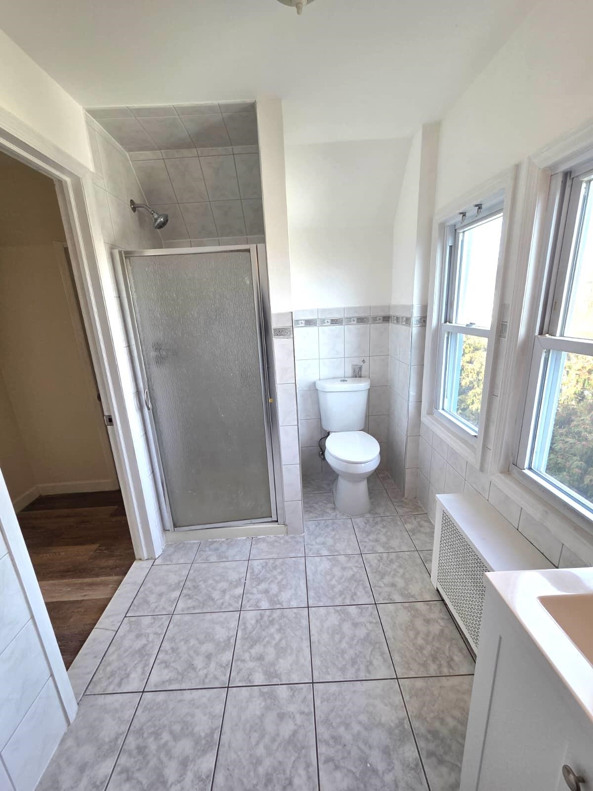 438 Devon Street, Unit 2 Kearny, NJ 07032 - Photo 18 of 27 a bathroom with a sink a toilet and a shower