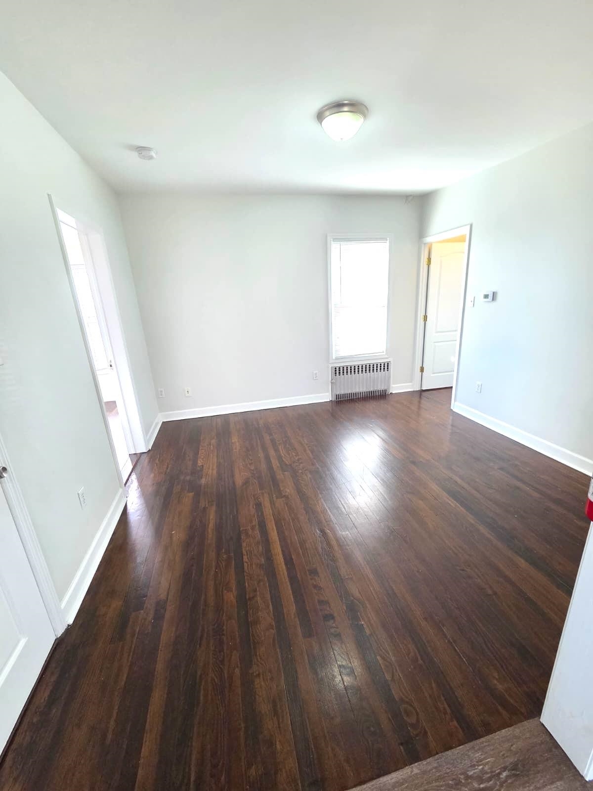 438 Devon Street, Unit 2 Kearny, NJ 07032 - Photo 4 of 27 wooden floor in an empty room with a window