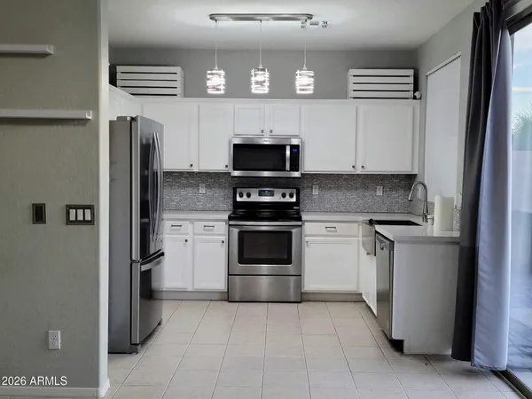 a kitchen with a stove and a refrigerator