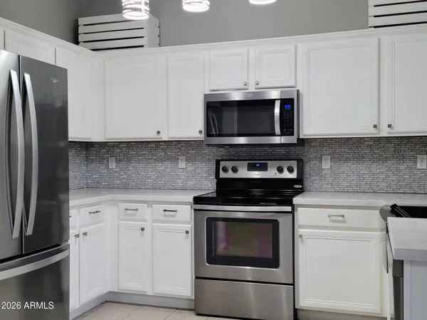 a kitchen with cabinets stainless steel appliances and cabinets