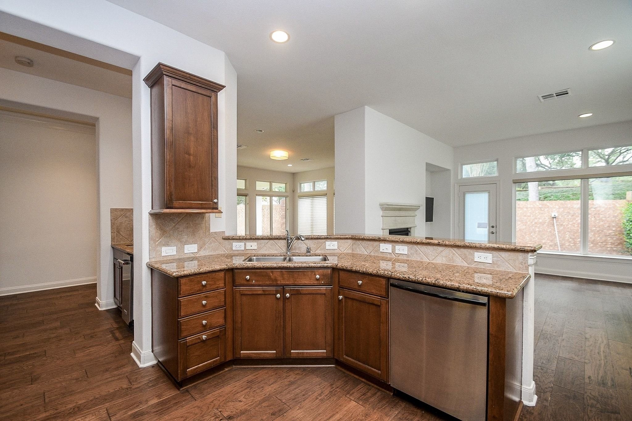 2826 Tudor Manor Houston, TX 77082 - Photo 14 of 37 This stunning view showcases the open-concept layout, connecting the spacious kitchen to the bright and airy family room and breakfast area.