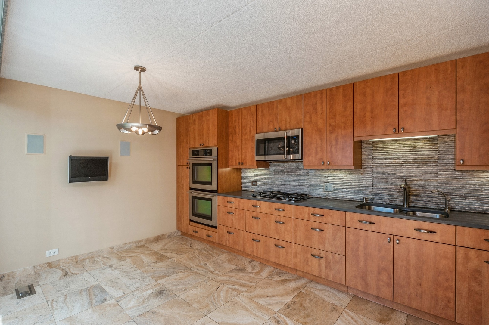 53 Avon Road Northbrook, IL 60062 - Photo 8 of 26 a kitchen with granite countertop a sink a stove and a microwave