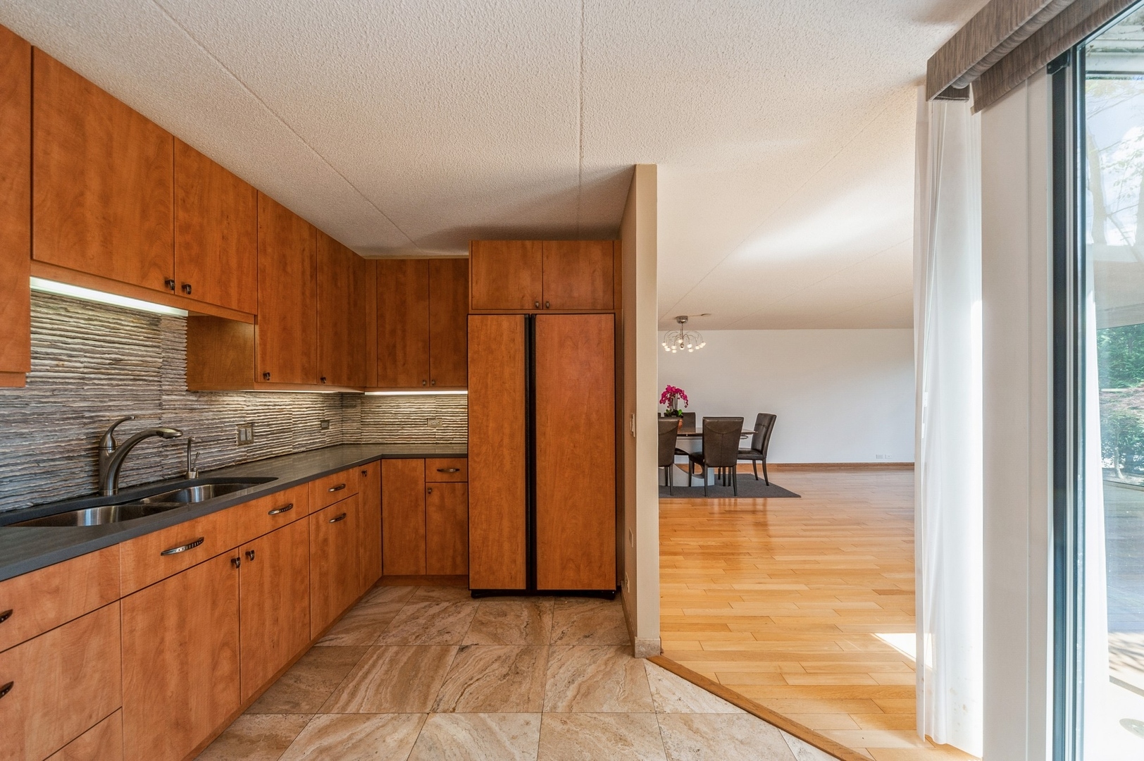 53 Avon Road Northbrook, IL 60062 - Photo 10 of 26 a kitchen with granite countertop a refrigerator and a sink