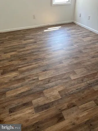 an empty room with wooden floor