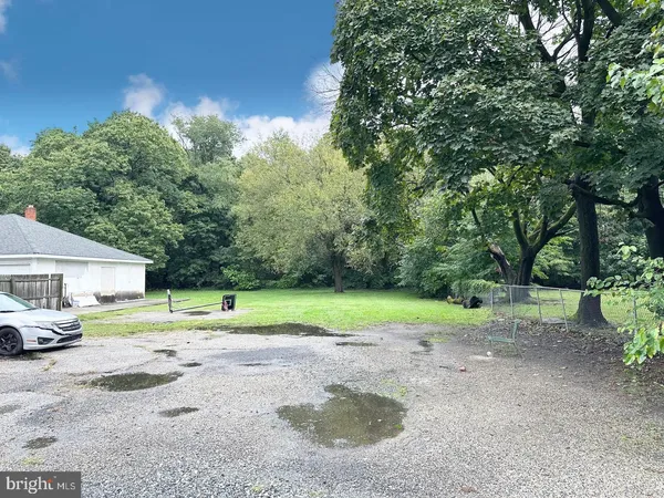a view of outdoor space with garden and trees