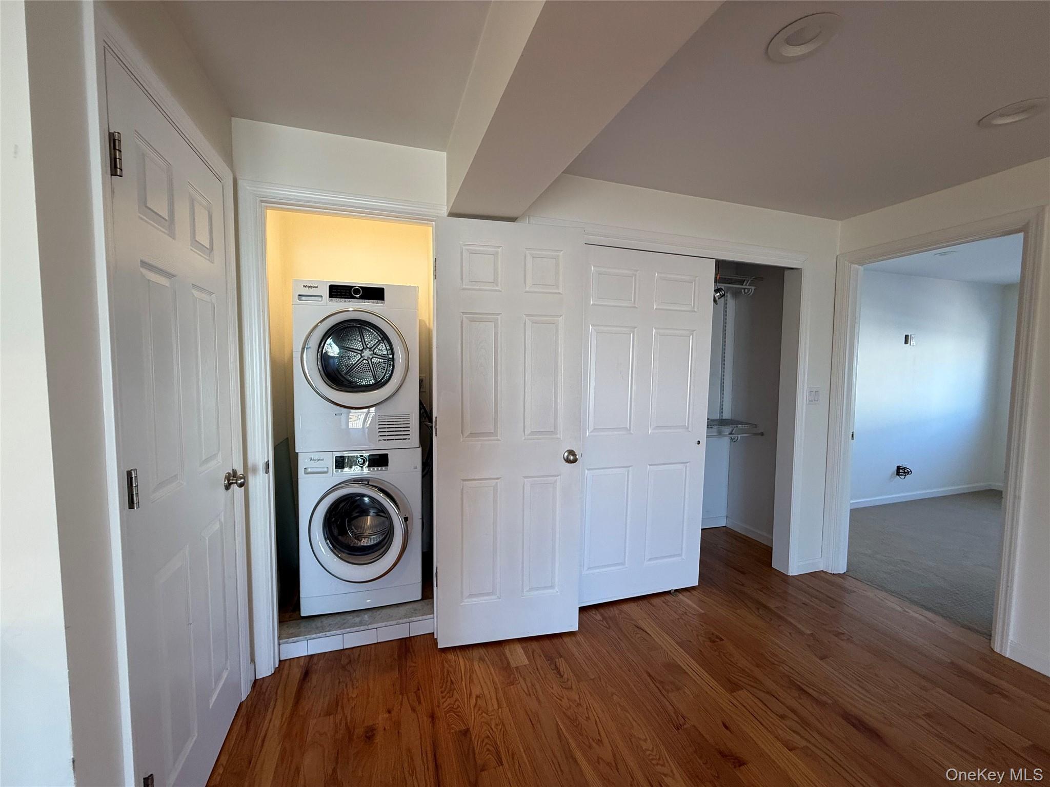 505 South Main Street Freeport, NY 11520 - Photo 7 of 10 Laundry area featuring wood finished floors and stacked washer / drying machine