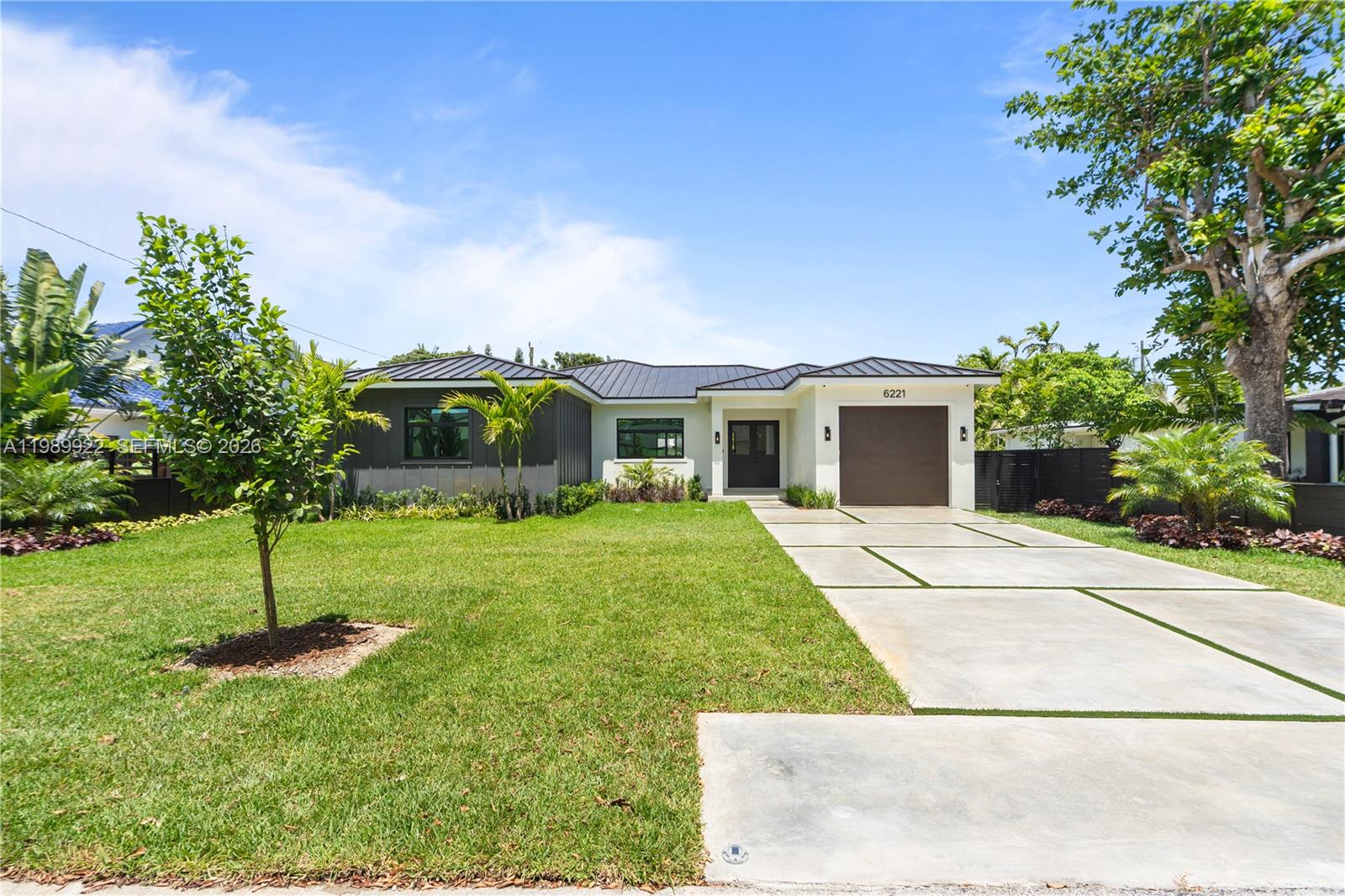 6221 Southwest 60th Street South Miami, FL 33143 - Photo 1 of 42 a front view of a house with a garden