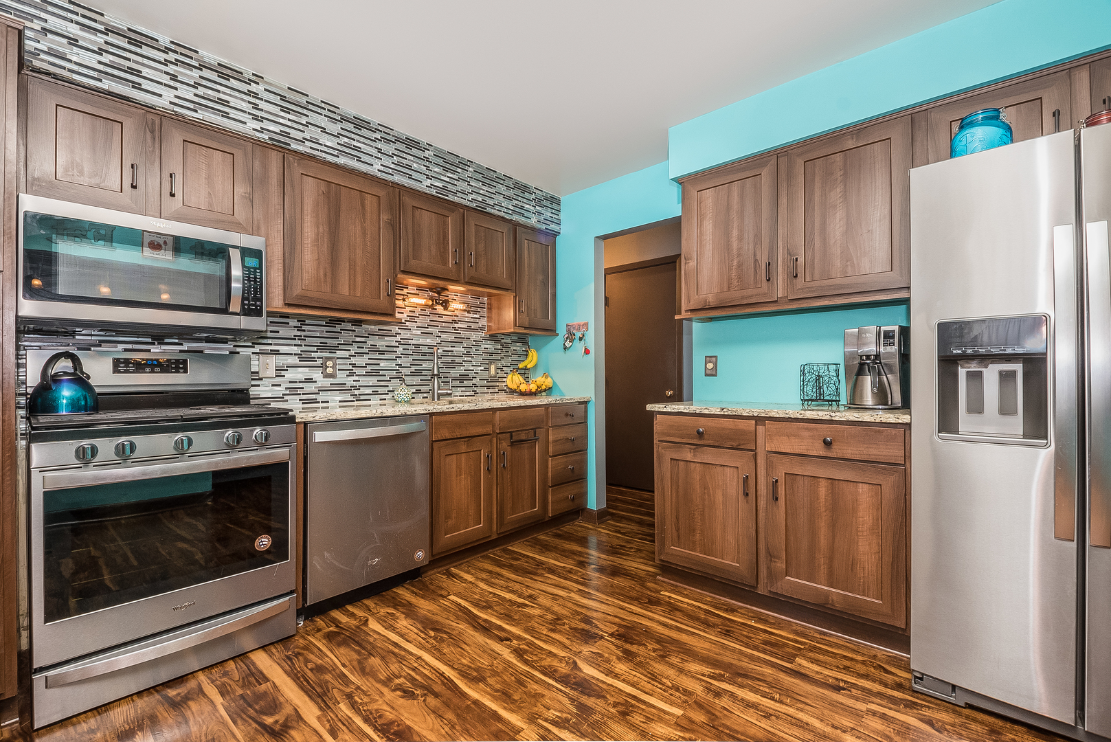 23 Fernwood Road Montgomery, IL 60538 - Photo 5 of 17 a kitchen with stainless steel appliances granite countertop a stove microwave and refrigerator