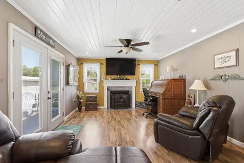 a living room with furniture a fireplace and a flat screen tv