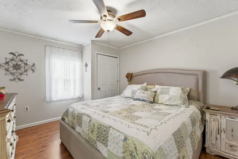 a bedroom with a large bed and a chandelier